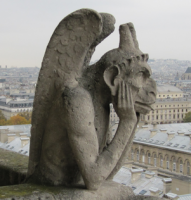 Gargoyle atop Notre Dame cathedral, Paris.
